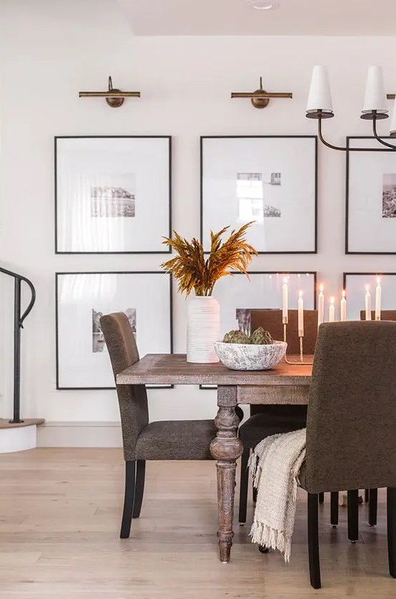 a modern gallery wall with black and white photos and with matching black frames is a very cool and stylish idea