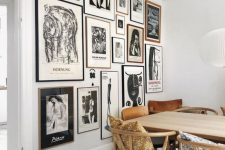 a monochromatic gallery wall with thin black and blonde wood frames and black and white artworks is a stylish idea