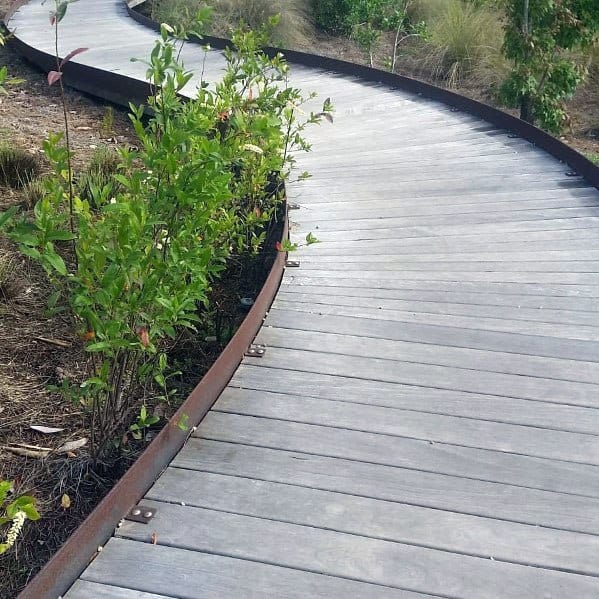 a reclaimed wood curved wooden walkway with a metal side is a lovely idea for a rustic inspired outdoor space a reclaimed wood curved wooden walkway with a metal side is a lovely idea for a rustic-inspired outdoor space