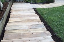 a reclaimed wooden walkway of pallets is a perfect idea for a rustic outdoor space, it will make your garden cozier
