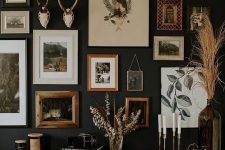 a refined and chic gallery wall with mismatching frames, artworks and antlers is a pretty idea with a vintage feel