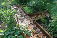 a small wood slice garden path plus a lawn looks very natural and eco-friendly, and you can easily DIY such a walkway