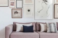 a sophisticated gallery wall with mismatching frames and mismatching artworks covering the wall horizontally is super stylish