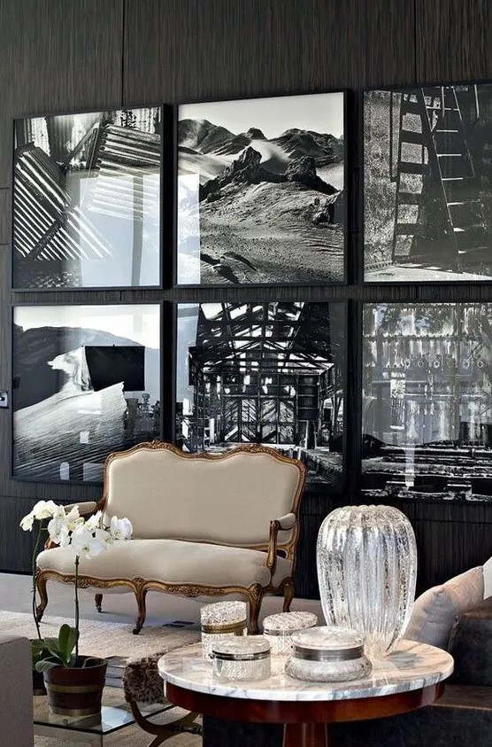 a statement gallery wall with thin black frames that seem invisible due to using black and white art and no matting