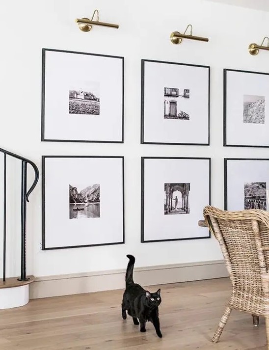 a statement grid gallery wall with matching black frames and black and white artworks with matting is a stylish idea to rock