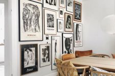 a stylish Scandinavian dining room with a light-stained table and matching chairs, a statement black and white gallery wall