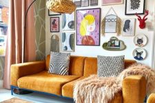 a super colorful and chic free form gallery wall with bold artworks and prints of various kinds, a mirror, decorative plates and faux taxidermy