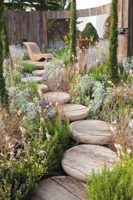a super eye catchy round wooden steps surrounded with catchy blooms and greenery is a unique idea for a modern space