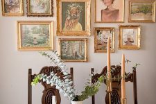 a vintage dining room with a dark-stained table and chairs, a chandelier and some pumpkins and a beautiful gallery wall with gold frames