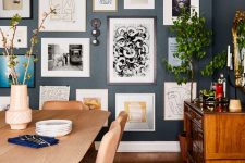 an exquisite graphite grey dining room with light-stained furniture and a rich-stained credenza, a free form gallery wall