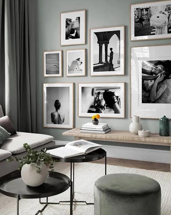 an eye-catchy black and white gallery wall with a free form and light-stained wooden frames for a more interesting look