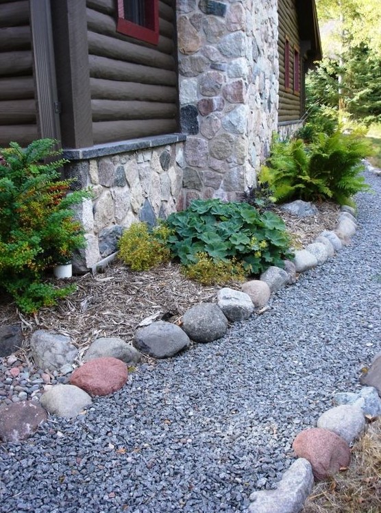 gravel and some stones match the stone cottage and look not too wild yet not too groomed