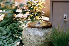 pretty and simpel front yard styling with an amphora fountain and potted grasses is amazing and very chic