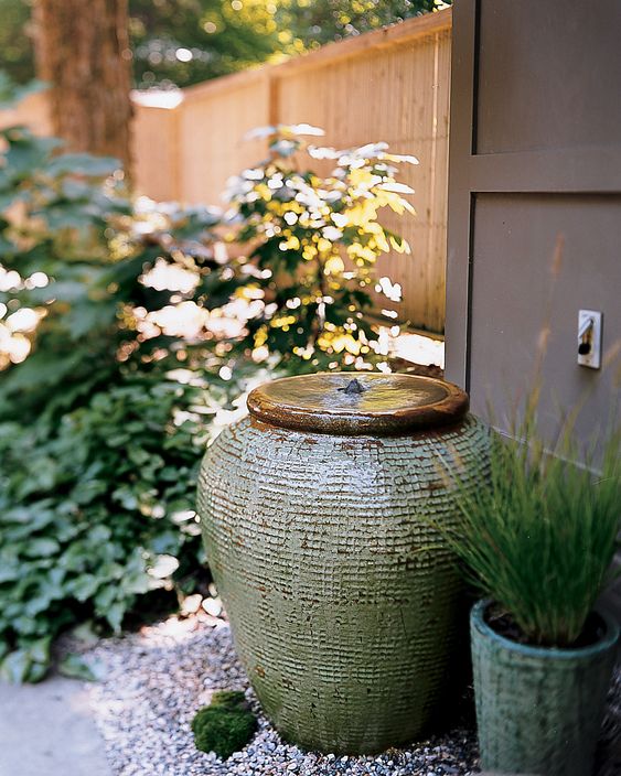 pretty and simpel front yard styling with an amphora fountain and potted grasses is amazing and very chic