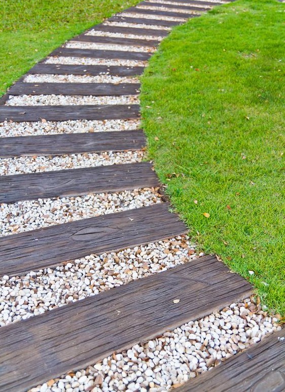 this curved walkway is comprised of alternating weathered wood and white pebble segments, perfect for a beach cottage garden this curved walkway is comprised of alternating weathered wood and white pebble segments, perfect for a beach cottage garden