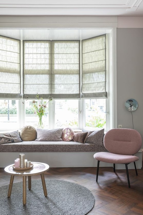 a cozy nook at the bow window, with semi sheer blinds and a windowsill daybed is a lovely solution for any space