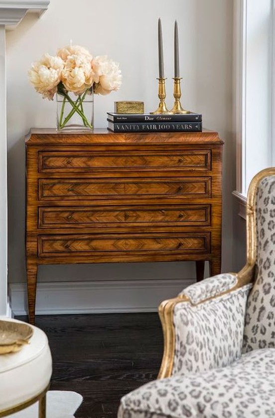 a beautiful stained vintage dresser, black books, chic candleholders and some blooms are a perfect combo for a refined living room
