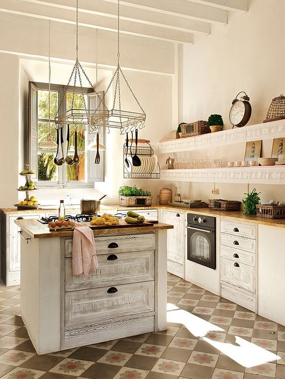 a beautiful white kitchen with a vintage-inspired whitewashed kitchen island for a trendy look