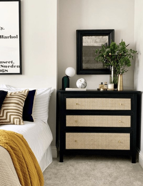a black dresser with cane drawers is a wonderful contrasting unit used as a nightstand is a very chic solution for a modern bedroom