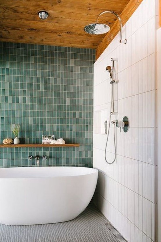 a bold contemproary bathroom with skinny white and mismatching green skinny tiles plus a grey mosaic tile floor
