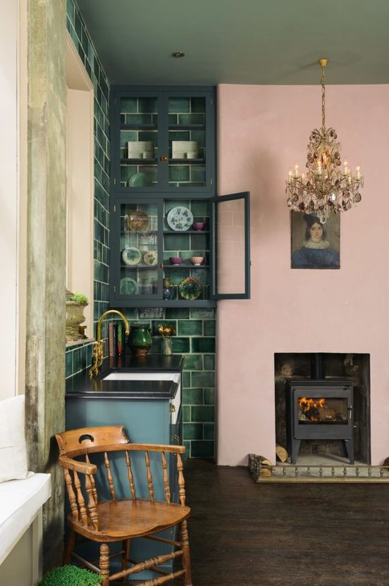 a bold kitchen spruced up with a vintage chandelier, artwork and a wooden chair to make it wow
