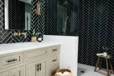 a chic black and white bathroom with chevron tiles, a greige wooden vanity, black fixtures and a wooden stool plus a basket for storage is cool