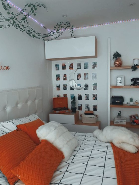 a chic teen room with a neutral bed, some storage units, lights, a gallery wall and floating shelves plus bright bedding