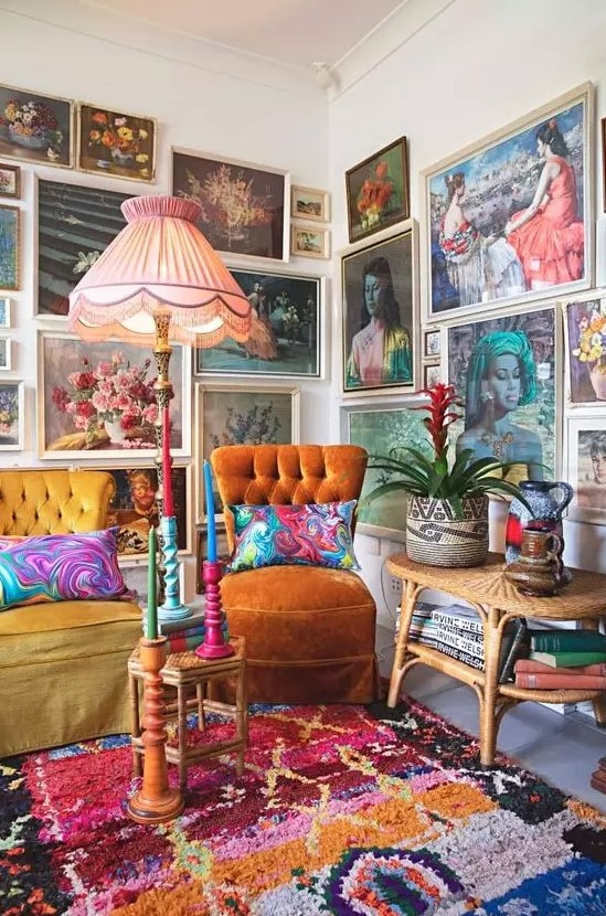 a colorful gallery wall taking two walls, with vintage paintings in neutral frames, with portraits and botanicals is amazing