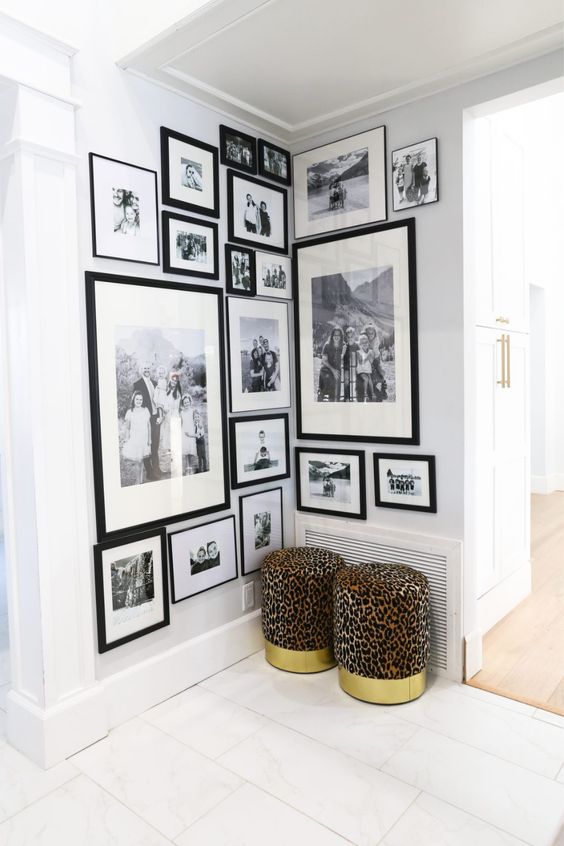 a large corner gallery wall of black and white family photos in matching black frames is a good idea to style an awkward nook