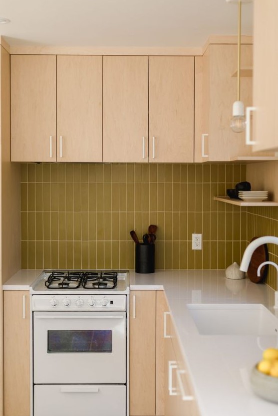 a light colored plywood kitchen with a mustard stacked tile backsplash and white fixtures for a fresh touch