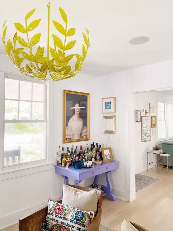 a mini gallery wall over the lilac home bar and a second one in the next room accent each space in a cool way
