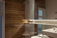 a minimalist bathroom clad with light stained wood, with a mirror wall and white appliances is pure luxury and invites in