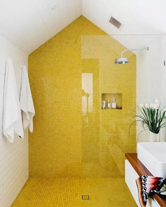 a modern bathroom with a lemon yellow tile shower and floor plus all white around looks bright and very fresh