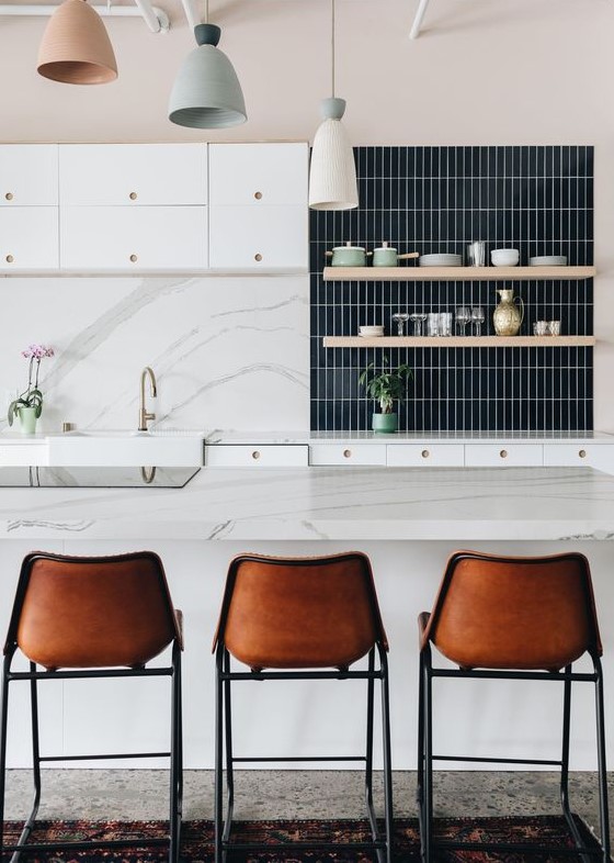 a navy skinny tile backsplash highlighted with white grout contrasts the white marble part on the left