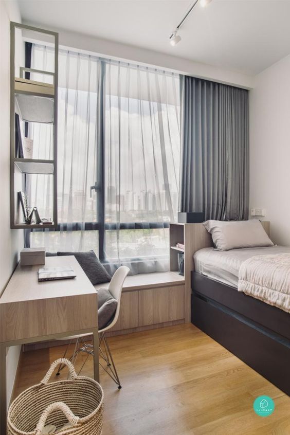 a neutral welcoming teen bedroom with a windowsill seat, a desk and a chair, a bed with storage drawers and a wall-mounted shelf