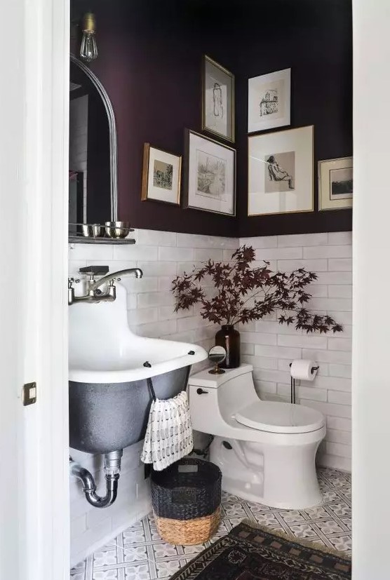 a refined moody mudroom with purple walls and white tiles, a black wall-mounted sink, a basket and some bulbs and lights