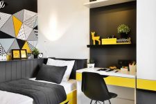 a small and brigth teen room with a built-in desk and shelves, a bold yellow bed with black and white bedding and bold art on the wall