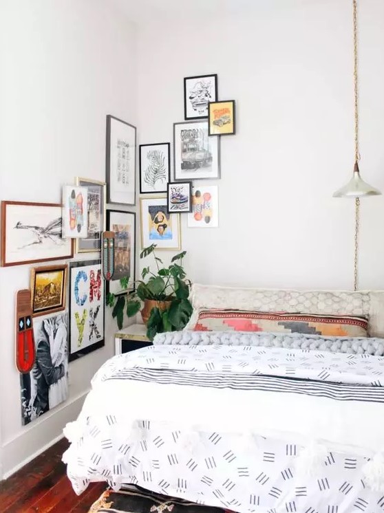 a small bedroom infused with color with printed textiles and a bolc gallery wall that goes to the corner and next wall