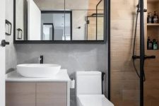 a small contemporary bathroom with a floating vanity, a shower space clad with wood tiles, a chevron floor, black touches for a contrast