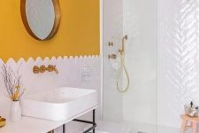 a stylish bathroom with a sunny yellow wall, white tiles, a round mirror and a neutral and lighweight vanity