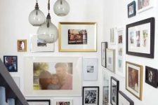 a stylish gallery wall with mismatching photos, frames of various sizes and colors is a very cool idea