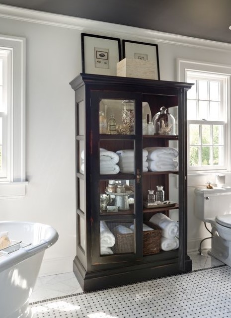 a stylish vintage black cabinet with glass doors and sides is a lovely idea for a bathroom, you will add a vintage feel to it easily