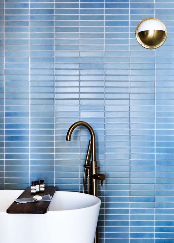 refresh your contemporary bathroom with laconic blue skinny tiles on the wall accented with white grout