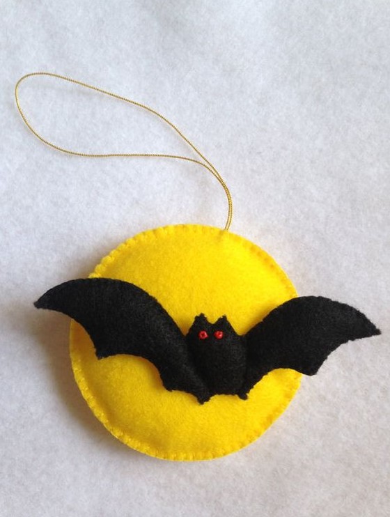 a bold Halloween ornament of felt showing a yellow moon and a bat is classics for this holiday and you can DIY it