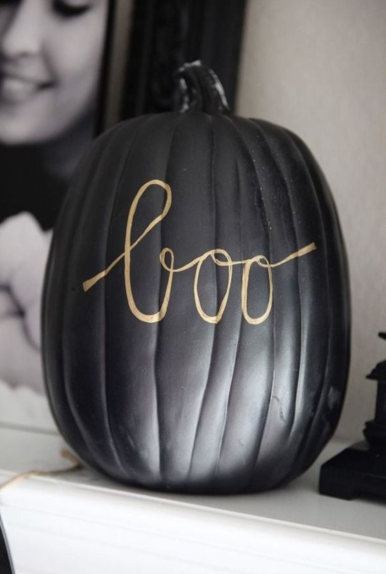 a matte black pumpkin with gold calligraphy letters made with a sharpie is a very easy and cool idea