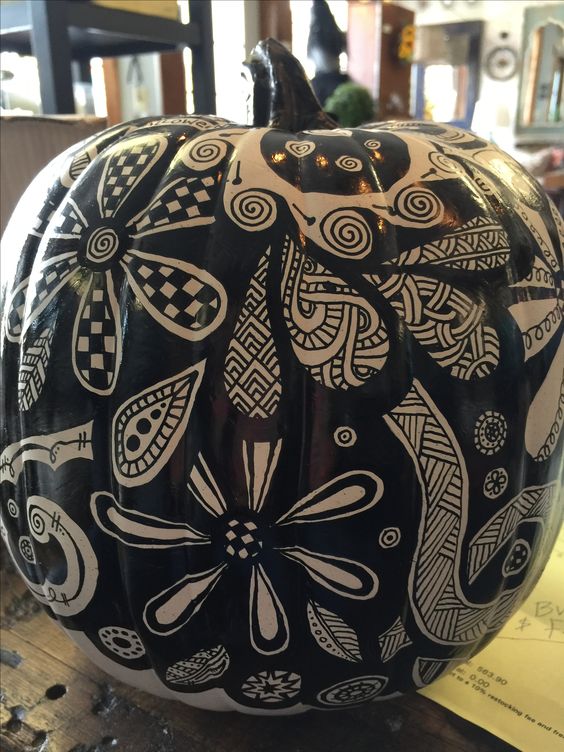 a black and white pumpkin with various patterns, flowers and leaves, done with a black sharpie is a nice and cool idea