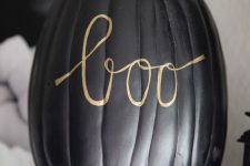 05 a black pumpkin decorated with a gold sharpie is a simple and stylish solution for modern Halloween decor