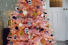 05 a pink Halloween tree decorated with black and white pompoms, lights and Polaroids in black and white is cool