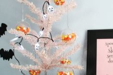 07 a blush Halloween tree decorated with skulls and with clear Halloween ornaments filled with corn candies