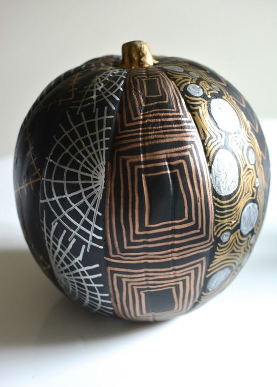 a chic black Hallowene pumpkin decorated with metallic sharpies with various patterns is a cool and fun idea